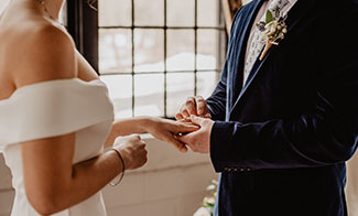 close up of bride and groom holding hands.jpg