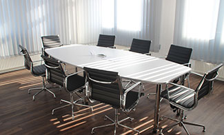 empty conference room table and chairs