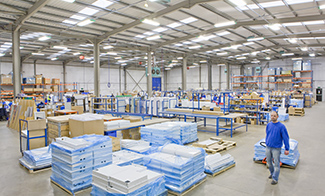 large warehouse interior with worker moving products