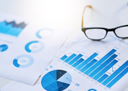 papers-with-charts-on-desk-with-a-pair-of-glasses
