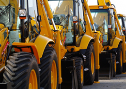 row-of-idle-construction-vehicles