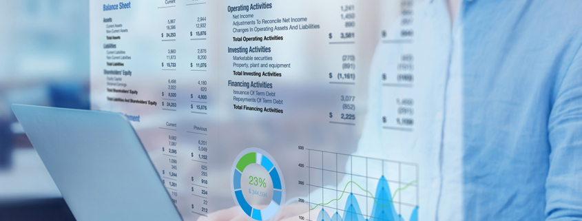 financial-statement-superimposed-over-man-at-laptop